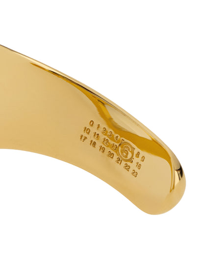 Bracelet by MM6 Maison Margiela for women in cotton gold showcases a luminous , artfully capturing the essence of the luminous Women's Gold Brass Bracelet collection.