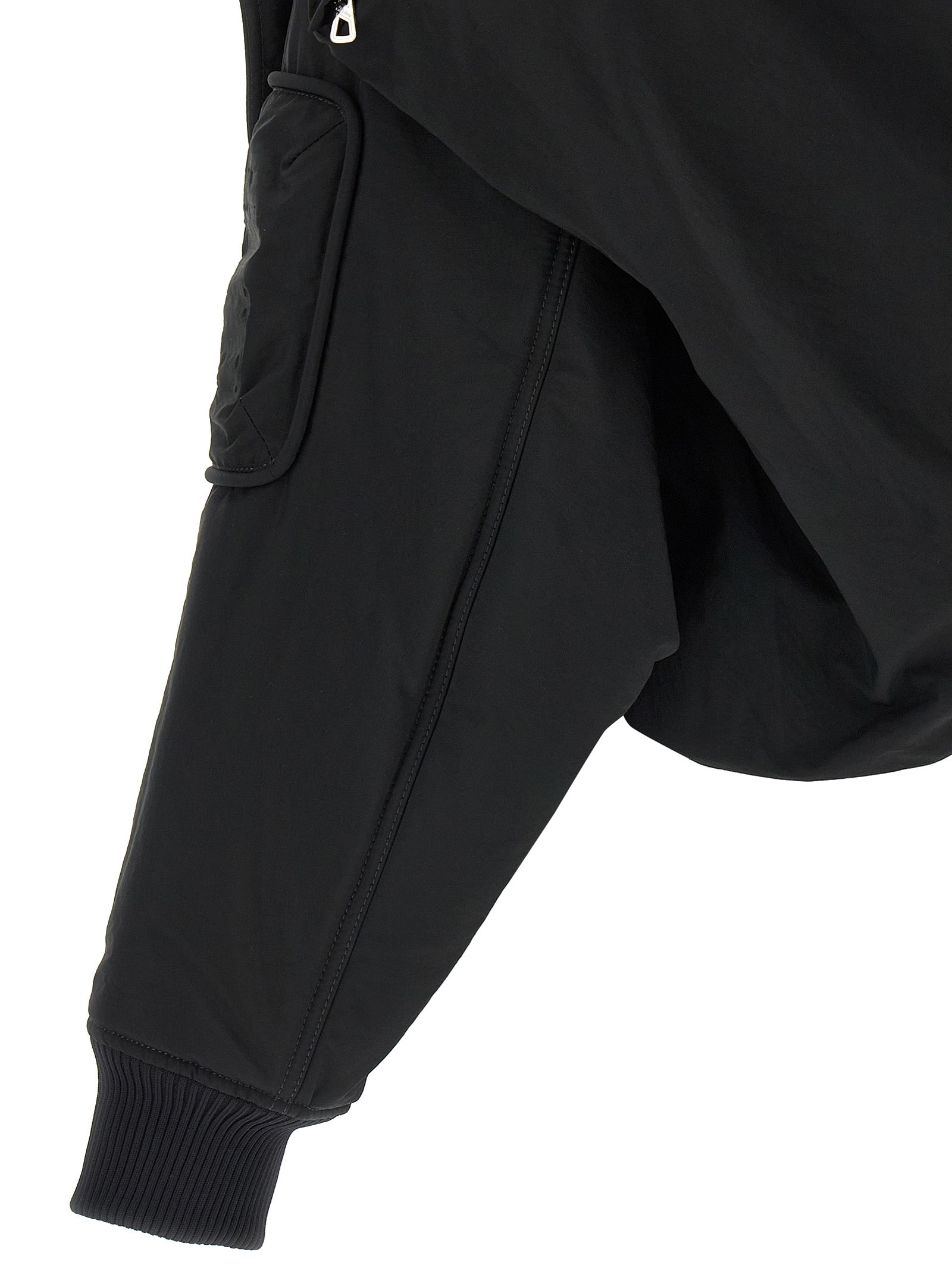 This Hooded Bomber Jacket by Jean Paul Gaultier for women in polyester polyurethane polyethylene black exhibits a edgy silhouette, meticulously detailed with functional pockets, hooded & insulated and a edgy for a edgy finish.