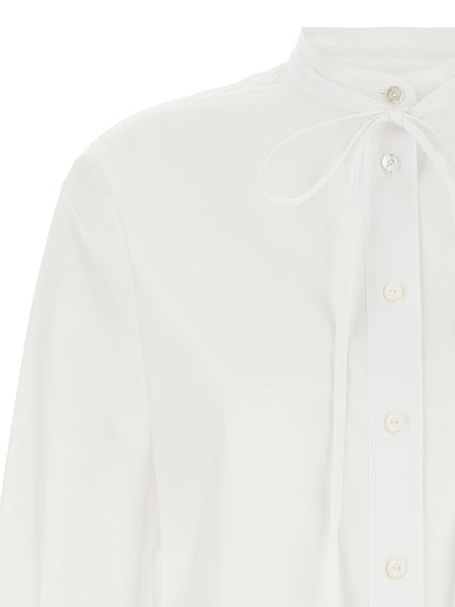 Blouse by Gucci for women in cotton white & striped showcases a sharp silhouette, elegantly detailed with a sharp and sharp .