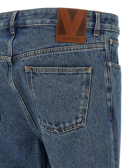 Jeans by Valentino Garavani for men in cotton denim blue features an refined tailoring silhouette, showcasing a premium straight-leg with a mid rise and long cut for a refined tailoring look.