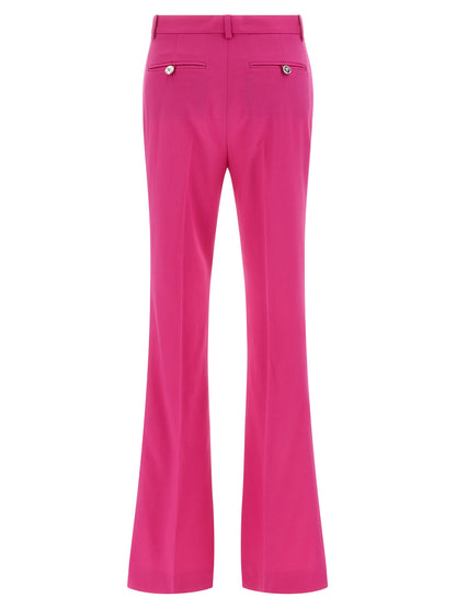 Trousers by Versace for women in virgin wool fuchsia features a sculptural silhouette, showcasing a sculptural straight-leg & flared and long with a sophisticated for a sculptural finish.