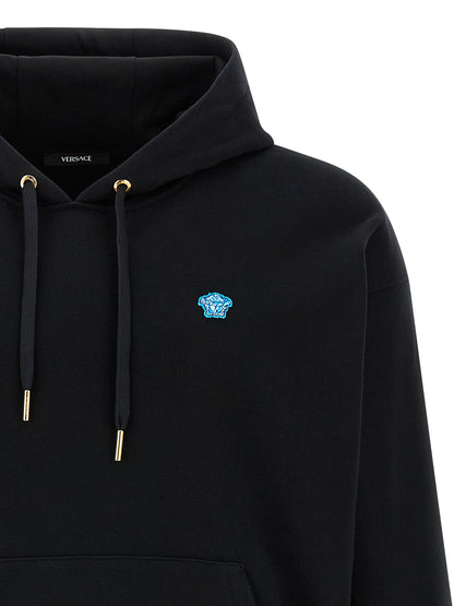 Sweatshirt Hoodie by Versace for men in cotton black features an luminous silhouette, showcasing a sophisticated hooded neckline and for a truly luminous look.