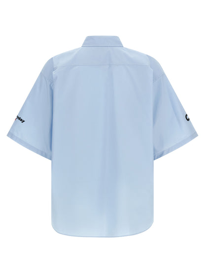 Shirt by Balenciaga for men in cotton light-blue presents a discerning silhouette, showcasing a sophisticated and for a truly discerning finish.