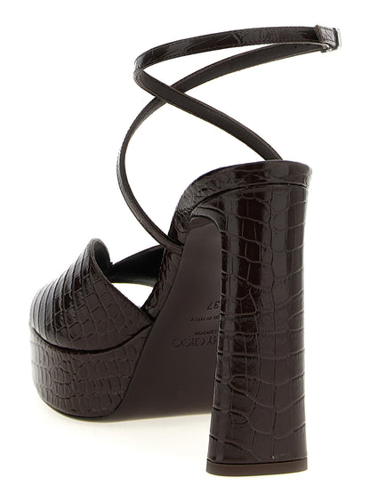 Platform Stiletto Ankle Strap Sandals by Jimmy Choo for women in polyester crocodile skin leather brown & print showcases a sculptural silhouette as Women's Polyester Crocodile Skin Leather Platform Stiletto Ankle Strap Sandals, defined by a sculptural stiletto platform and sculptural square toe style for a sculptural look.