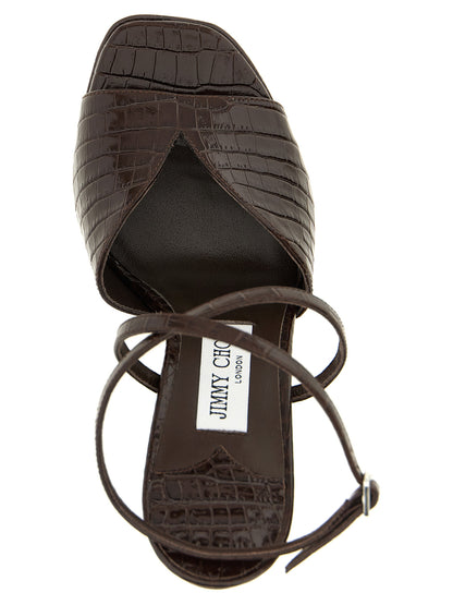 Platform Stiletto Ankle Strap Sandals by Jimmy Choo for women in polyester crocodile skin leather brown & print features an statuesque Women's Polyester Crocodile Skin Leather Platform Stiletto Ankle Strap Sandals silhouette with a refined stiletto platform and elegant square toe style.