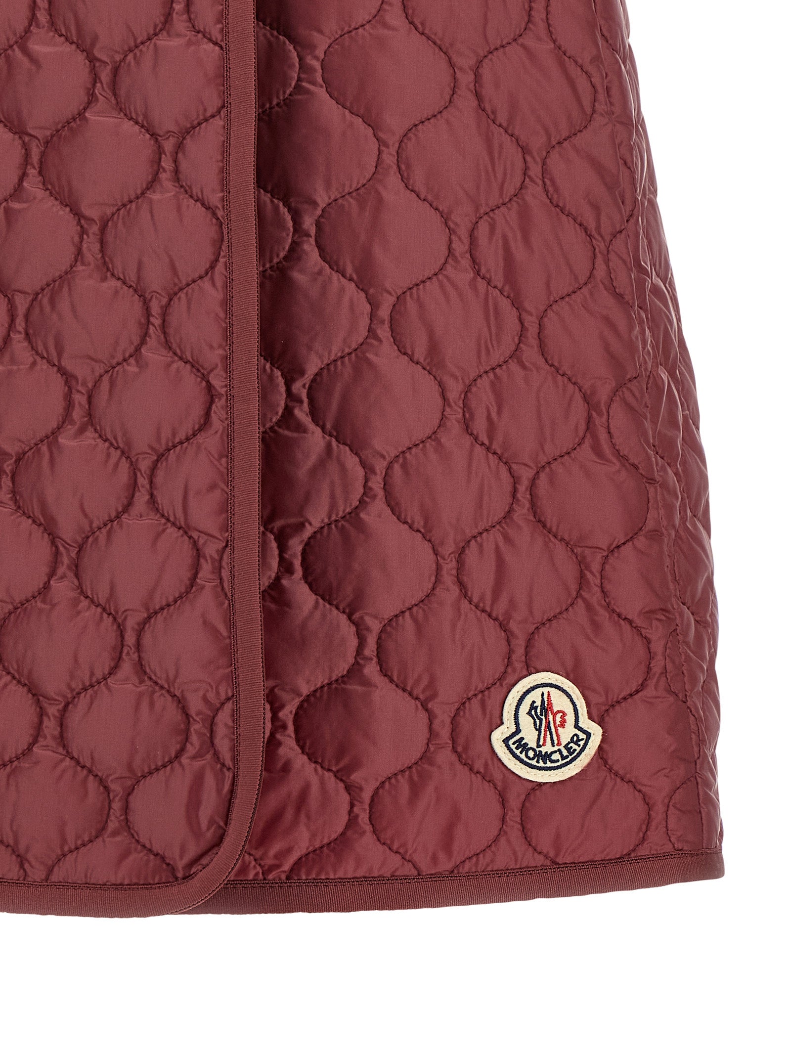 Skirt by Moncler for women in polyamide felt bordeaux showcases a sultry silhouette, elegantly defined by its long and the sophisticated sultry design of the Women's Polyamide Felt Long Skirt.
