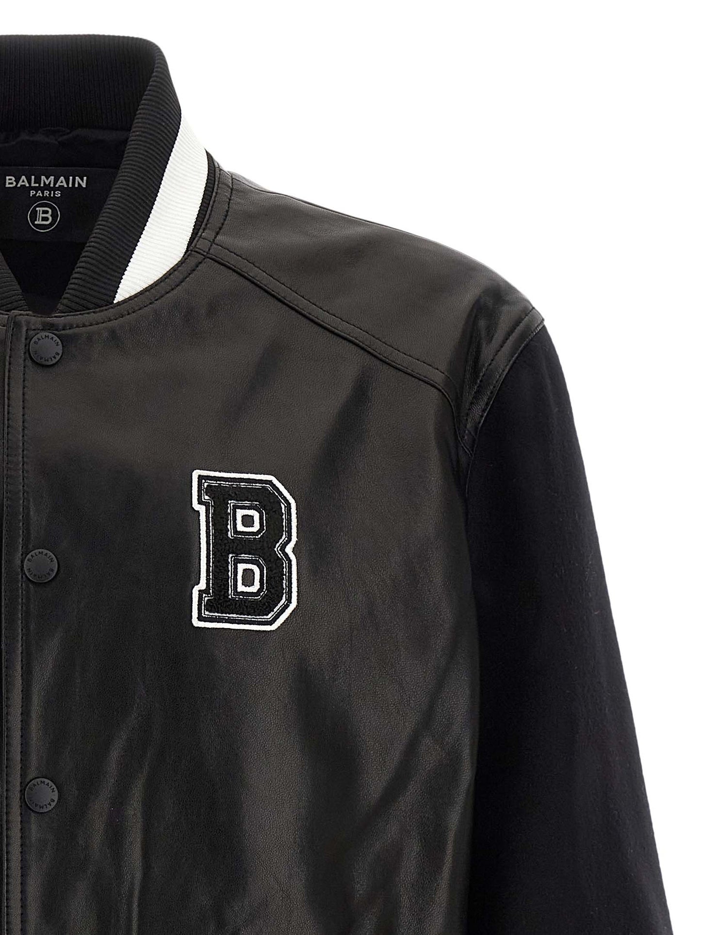 This Bomber Jacket by Balmain for men in lamb leather & cupro bicolour, black, white & signature exhibits a edgy silhouette, meticulously detailed with functional pockets and a edgy for a edgy finish.