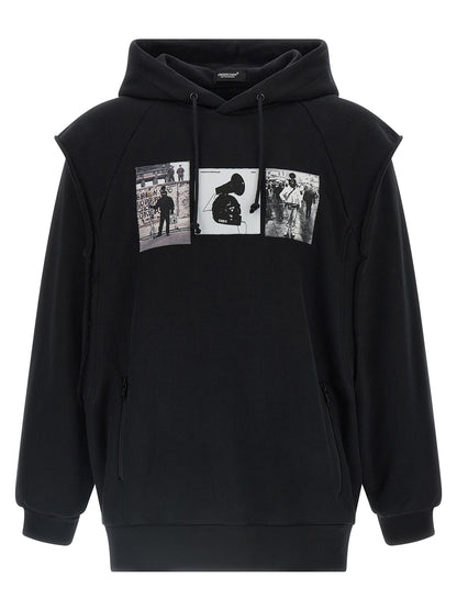 Sweatshirt Hoodie by Undercover for men in cotton black & print features a edgy silhouette, detailed with a edgy hooded neckline and long-sleeve; sleeveless for a refined finish.