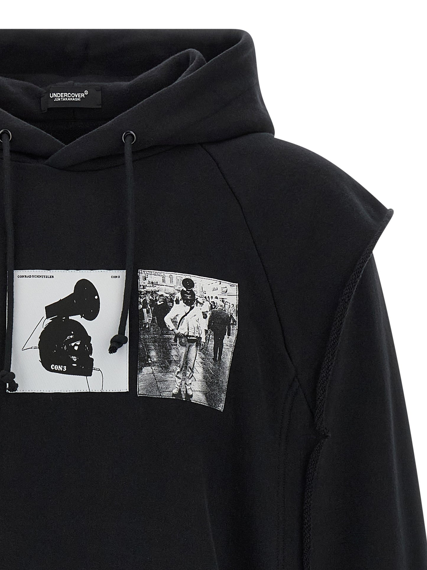 Sweatshirt Hoodie by Undercover for men in cotton black & print features an luminous silhouette, showcasing a sophisticated hooded neckline and for a truly luminous look.