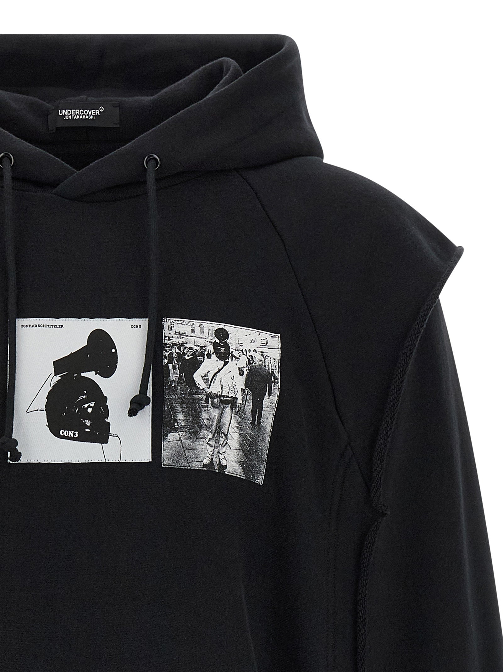 Sweatshirt Hoodie by Undercover for men in cotton black & print features an luminous silhouette, showcasing a sophisticated hooded neckline and for a truly luminous look.