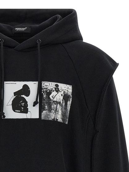 Sweatshirt Hoodie by Undercover for men in cotton black & print features an luminous silhouette, showcasing a sophisticated hooded neckline and for a truly luminous look.