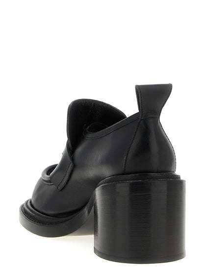 Platform Geometric Loafer Work Shoes by Moschino for women in calfskin leather black showcases a timeless silhouette from the College Olivia Play Women's Calfskin Leather Platform Geometric Loafer Work Shoes collection, featuring a timeless platform geometric-heel and for a timeless finish.