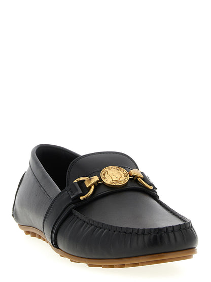 Loafer Slip-On Shoes by Moschino for men in leather & rubber black features an effortless chic silhouette, showcasing the Men's Leather & Rubber Loafer Slip-On Shoes design with an effortless chic and a for a effortless chic look.