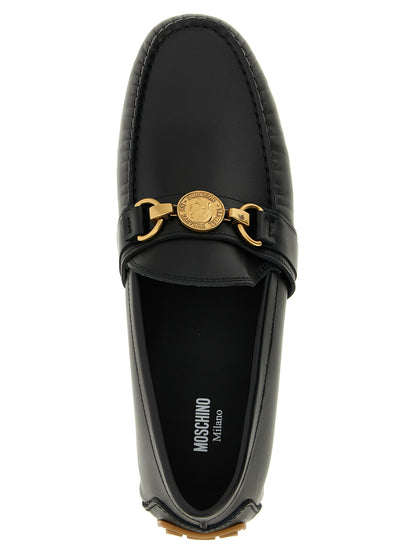 This Loafer Slip-On Shoes by Moschino for men in leather & rubber black features an exquisite silhouette from the Men's Leather & Rubber Loafer Slip-On Shoes collection, defined by a sophisticated and elegant .