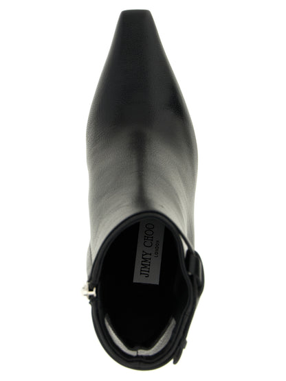 Stiletto Ankle Cut-Out Strap Boots by Jimmy Choo for women in plastic leather & silk black showcases a impeccable silhouette as Women's Plastic Leather & Silk Stiletto Ankle Cut-Out Strap Boots, artfully defined by a impeccable stiletto and a impeccable square toe style.