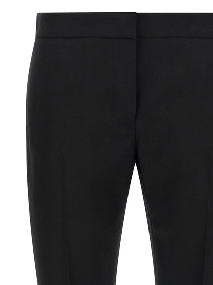 Trousers by Alexander McQueen for women in wool black presents a smart silhouette, meticulously detailed with a smart straight-leg & cigarette, a smart long, and a smart .
