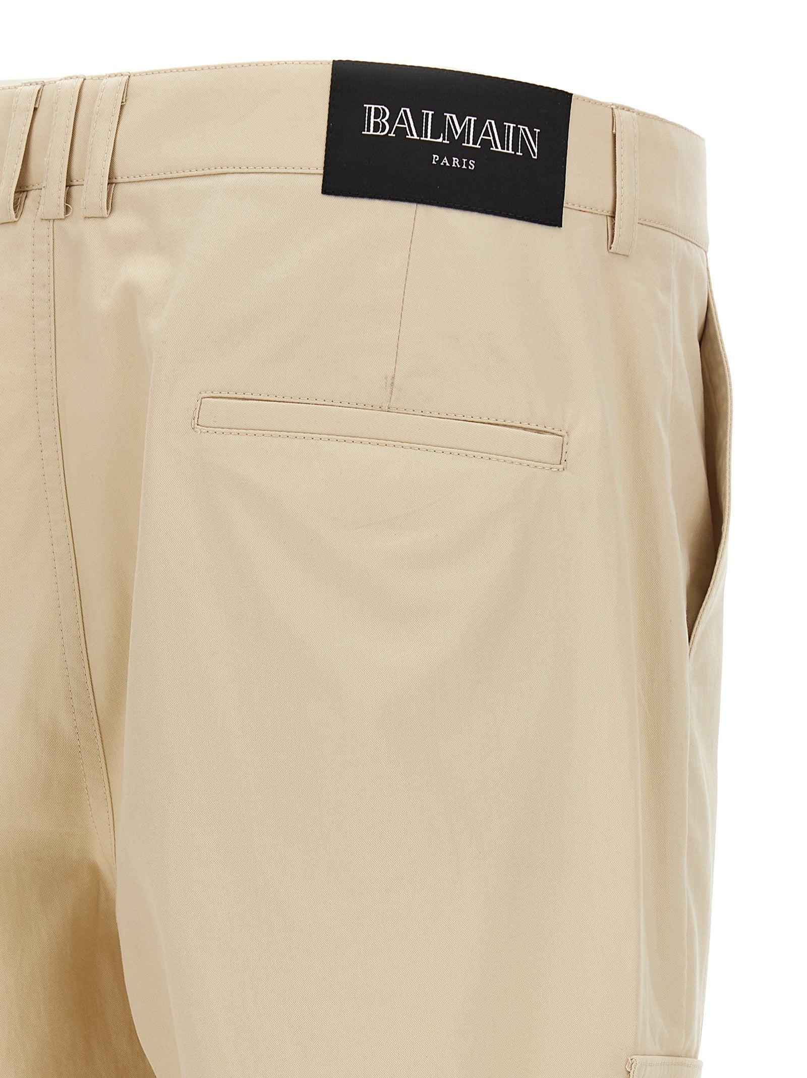 Cargo Pants by Balmain for men in cotton beige & signature features an smart casual straight-leg and long, expertly tailored with a and smart casual utilitarian details for a sophisticated look.