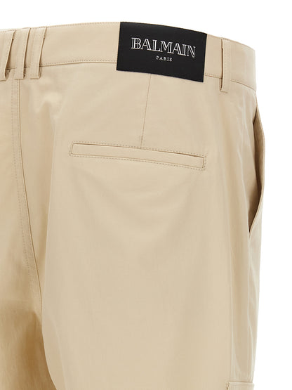 Cargo Pants by Balmain for men in cotton beige & signature features an smart casual straight-leg and long, expertly tailored with a and smart casual utilitarian details for a sophisticated look.