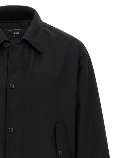 Overcoat by Comme Des Garçons for men in wool & polyester black showcases a enveloping silhouette, detailed with distinctive pockets and a enveloping .