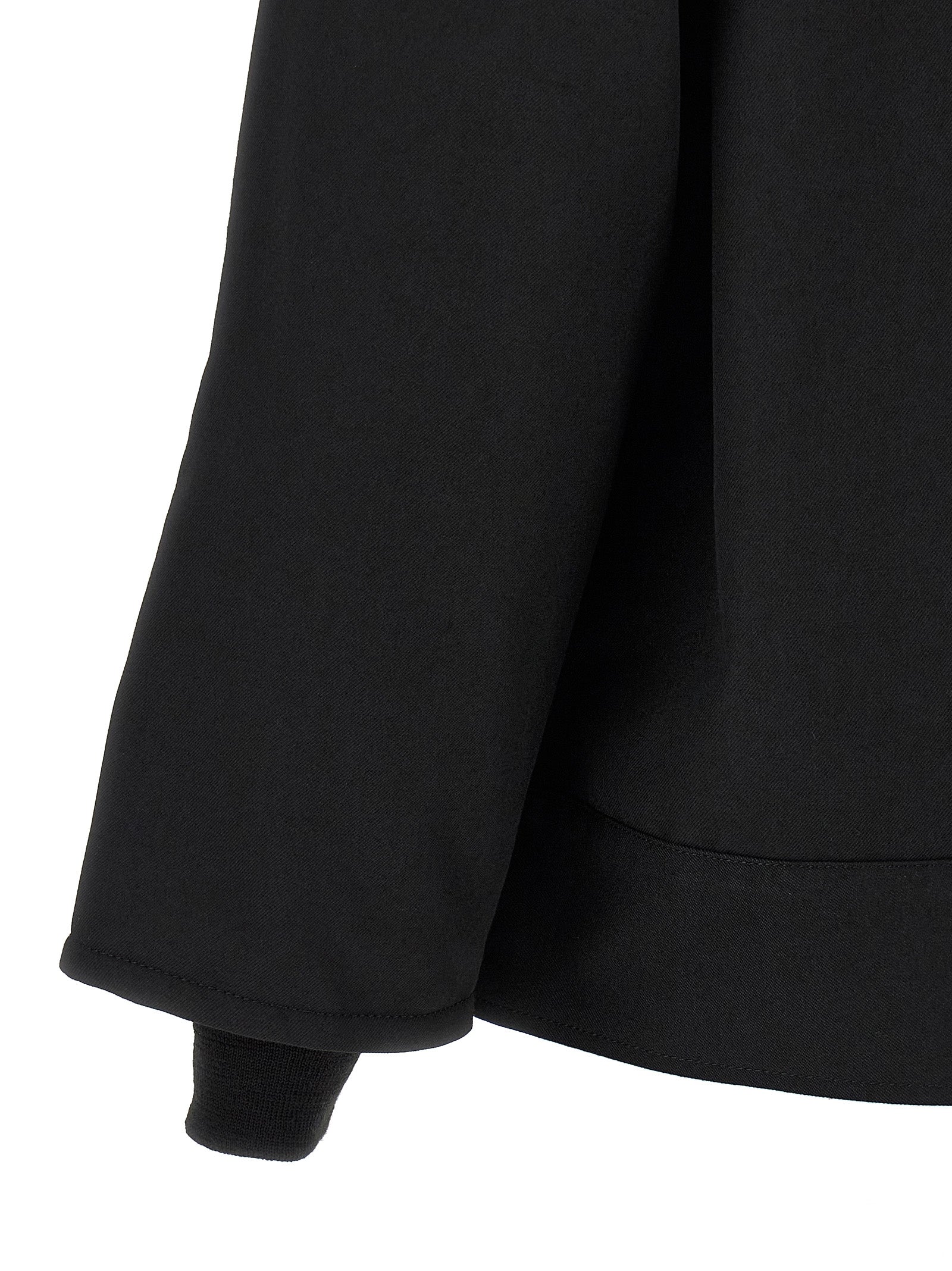 Overcoat by Comme Des Garçons for men in wool & polyester black showcases a enveloping silhouette, detailed with distinctive pockets and a enveloping .