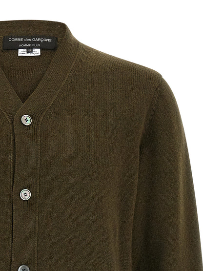 Cardigan by Comme Des Garçons for men in wool & nylon bicolour, green & jacquard showcases a captivating silhouette, artfully detailed with a captivating and v-neck neckline for a truly sophisticated captivating look.