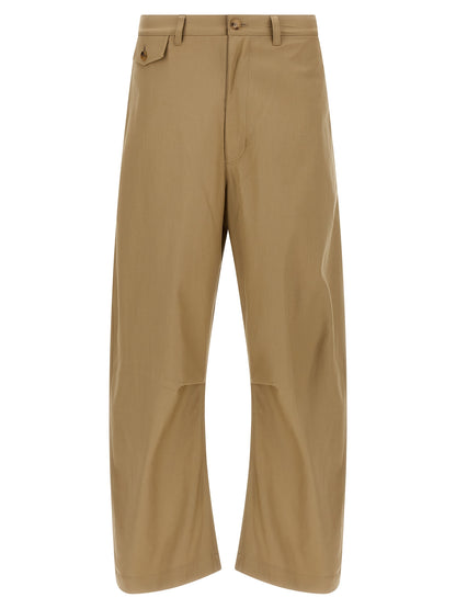 Trousers by Comme Des Garçons for men in cotton beige features a artisanal silhouette, showcasing a sophisticated with a long and for a artisanal finish.