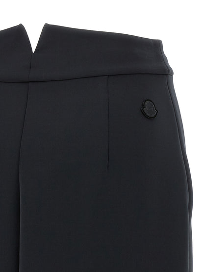 Skirt by MONCLER GENIUS for women in stretch polyester black showcases a sultry silhouette, elegantly defined by its midi and the sophisticated sultry design of the Women's Stretch Polyester Midi Skirt.