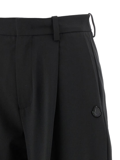 Trousers by MONCLER GENIUS for women in polyester & virgin wool black features a sculptural silhouette, showcasing a sculptural and long with a sophisticated for a sculptural finish.