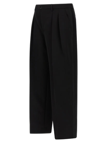 Trousers by Dolce & Gabbana for men in virgin wool black presents a perennial silhouette, meticulously tailored with a straight-leg & wide cut, long finish, and an elegant .