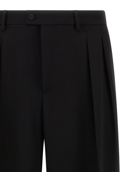 Trousers by Dolce & Gabbana for men in virgin wool black presents a smart silhouette, meticulously detailed with a smart straight-leg & wide, a smart long, and a smart .