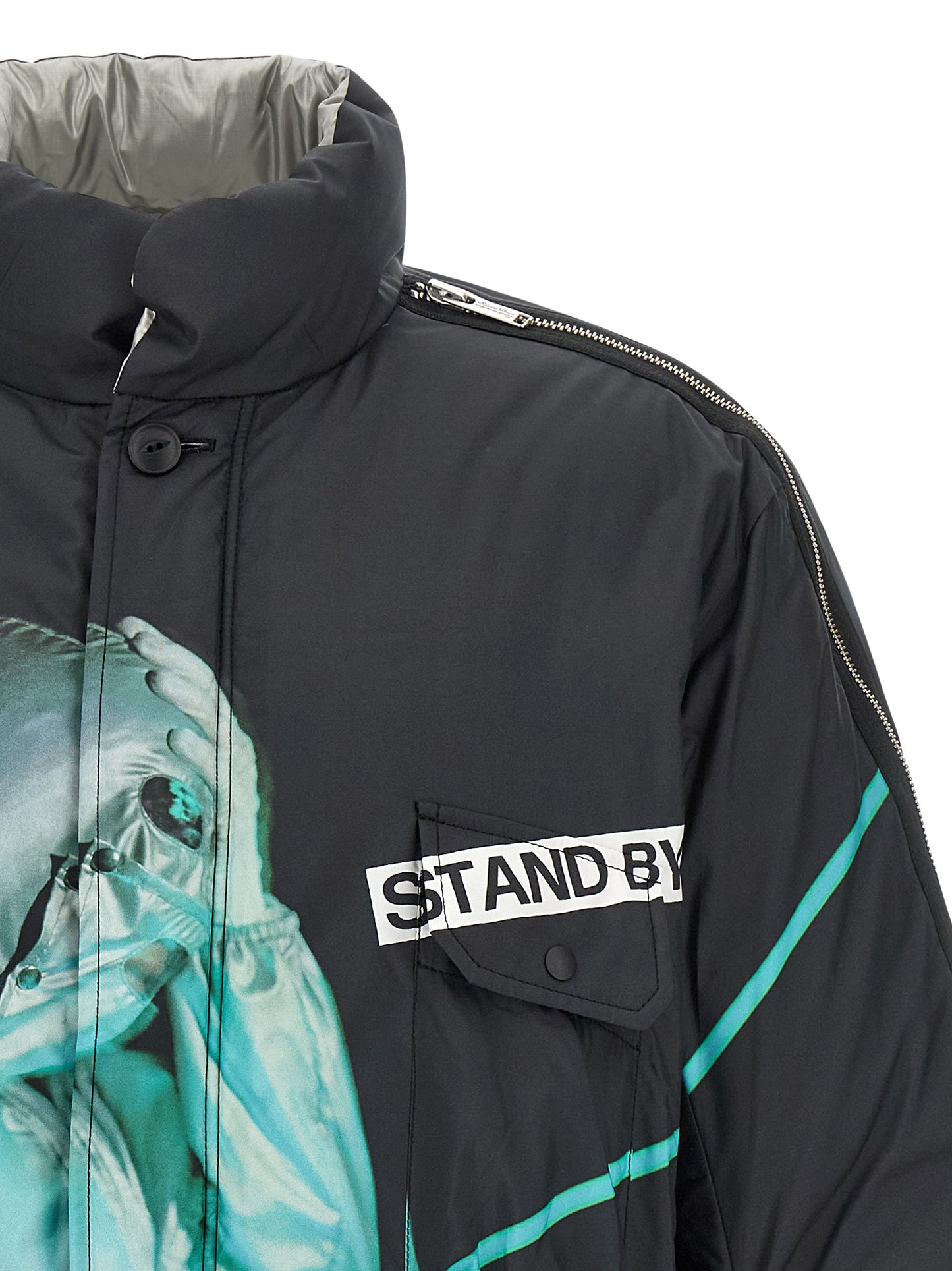 Puffer Jacket by Undercover for men in nylon & polyester black & print features a dramatic silhouette, showcasing a sophisticated high-neck neckline and distinctive insulated & windproof for a dramatic aesthetic.