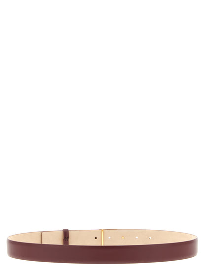 Belt by Khaite for women in calfskin & brass bordeaux & gold features an artisanal finish, elegantly showcasing the signature style and artisanal craftsmanship of the Calfskin & Brass Belt design.