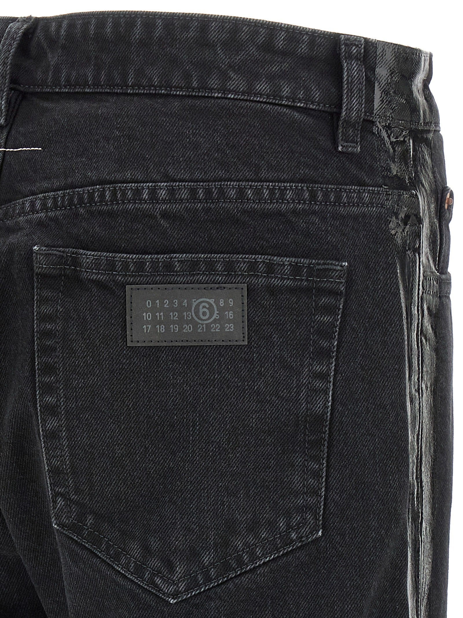 Jeans by MM6 Maison Margiela for men in denim cotton black, white & signature presents a tailored silhouette, showcasing a tailored tapered-leg & straight-leg and long cut with a refined for a truly tailored aesthetic.