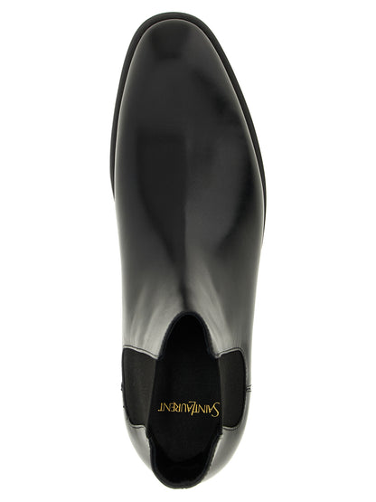 Ankle Chelsea Boots by Saint Laurent for men in calfskin leather black features an avant-garde Men's Calfskin Leather Ankle Chelsea Boots silhouette, defined by a sophisticated and a avant-garde almond toe style.