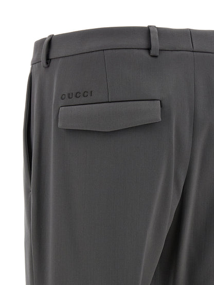 Trousers by Gucci for men in satin wool gray features a artisanal silhouette, showcasing a sophisticated straight-leg with a long and for a artisanal finish.