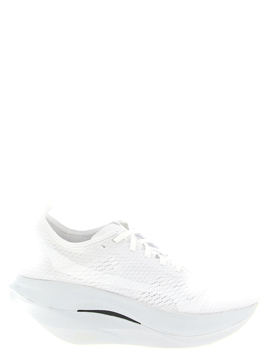 Athletic Sneakers by Comme Des Garçons for women in synthetic fabric white showcases a architectural silhouette, artfully capturing the essence of the Women's Athletic Synthetic Fabric Sneakers with its signature architectural athletic style construction.