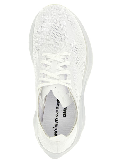 Athletic Sneakers by Comme Des Garçons for women in synthetic fabric white features an effortless chic silhouette, showcasing the signature athletic style of the Women's Athletic Synthetic Fabric Sneakers collection with a truly effortless chic finish.
