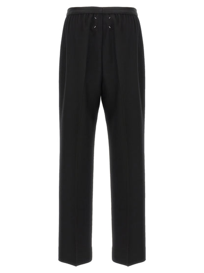 Trousers by Maison Margiela for women in virgin wool black presents a smart silhouette, meticulously detailed with a smart straight-leg, a smart long, and a smart .