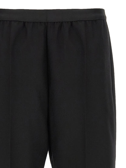Trousers by Maison Margiela for women in virgin wool black features an on trend silhouette, showcasing a sophisticated straight-leg with a long and for an on trend finish.
