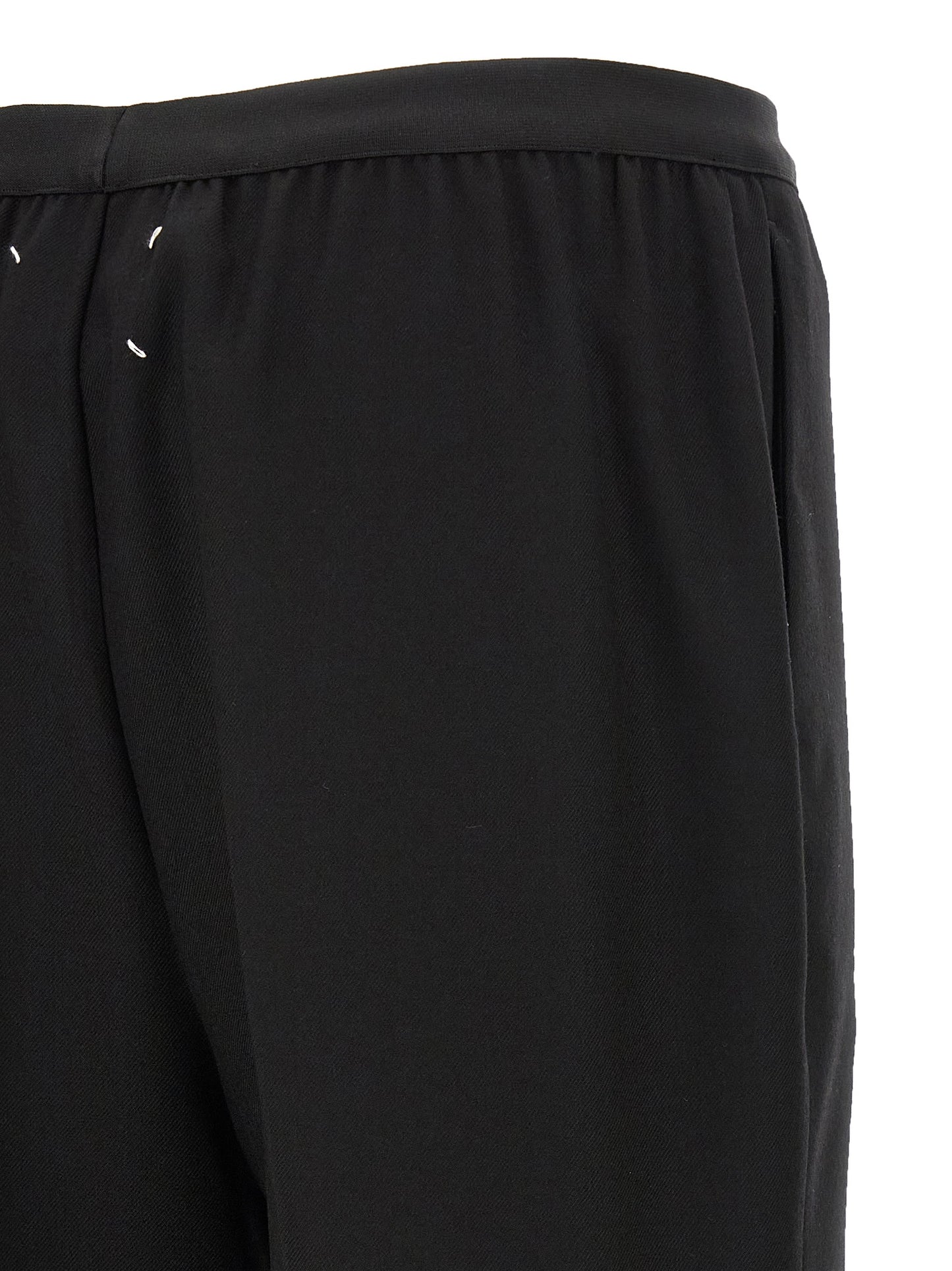 Trousers by Maison Margiela for women in virgin wool black presents a perennial silhouette, meticulously tailored with a straight-leg cut, long finish, and an elegant .