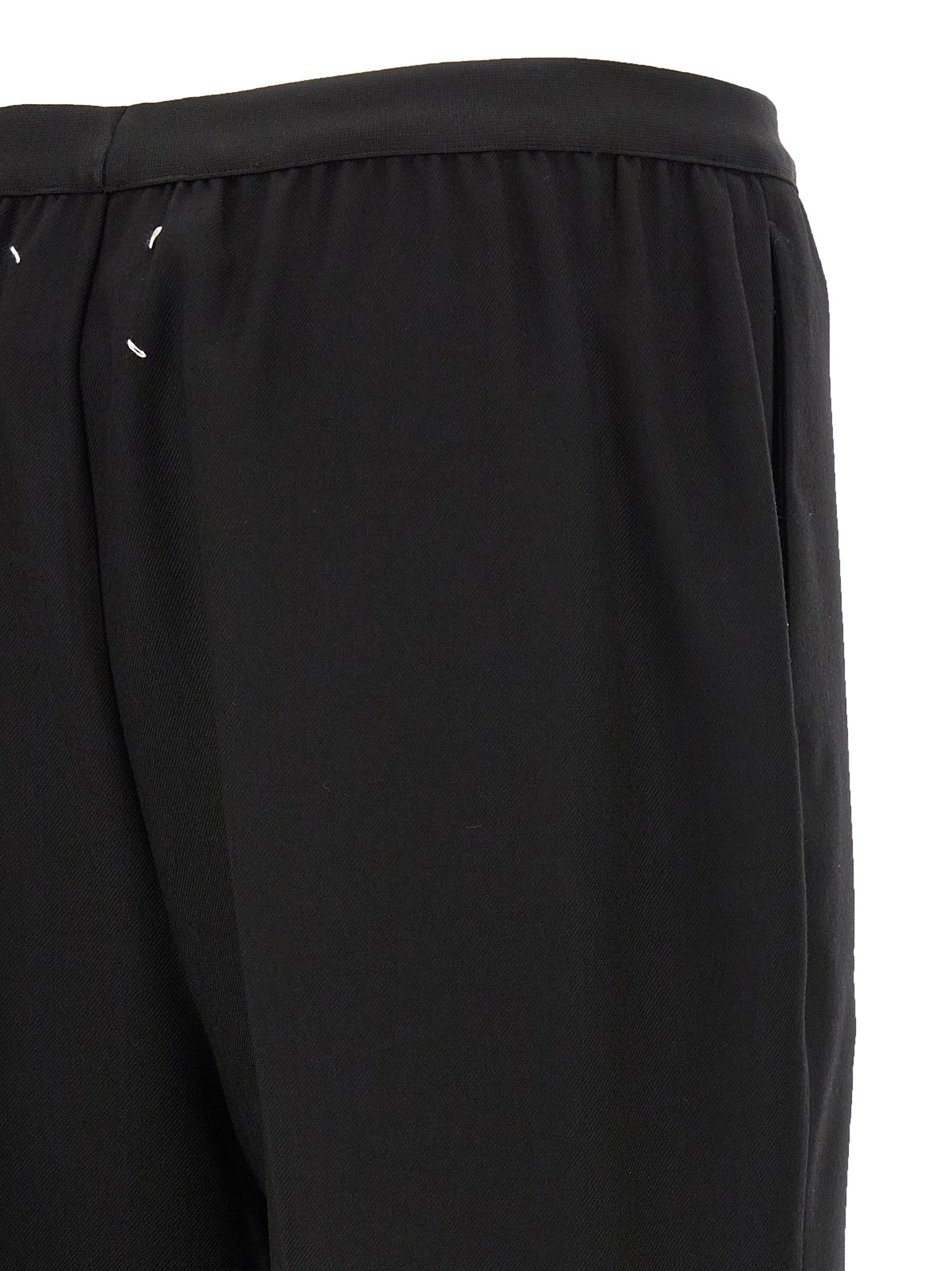 Trousers by Maison Margiela for women in virgin wool black presents a perennial silhouette, meticulously tailored with a straight-leg cut, long finish, and an elegant .