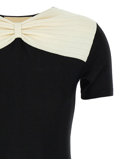 Dress by Valentino Garavani for women in polyester & viscose black features a dramatic silhouette, showcasing an elegant v-neck neckline and that flows into a dramatic short mini.