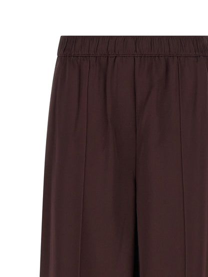 Trousers by Tory Burch for women in viscose bordeaux features a tailored silhouette with a tailored straight-leg, defined by its long and a sophisticated .