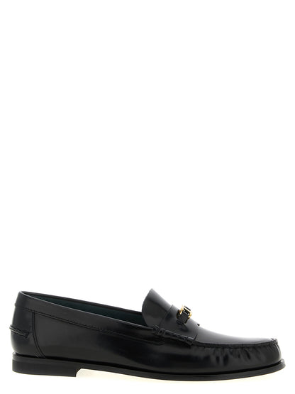 Flat Loafer Slip-On Shoes by Tod's for women in calfskin leather black & gold features an effortless chic silhouette, showcasing the T Timeless Women's Calfskin Leather Flat Loafer Slip-On Shoes design with an effortless chic flat and a for a effortless chic look.