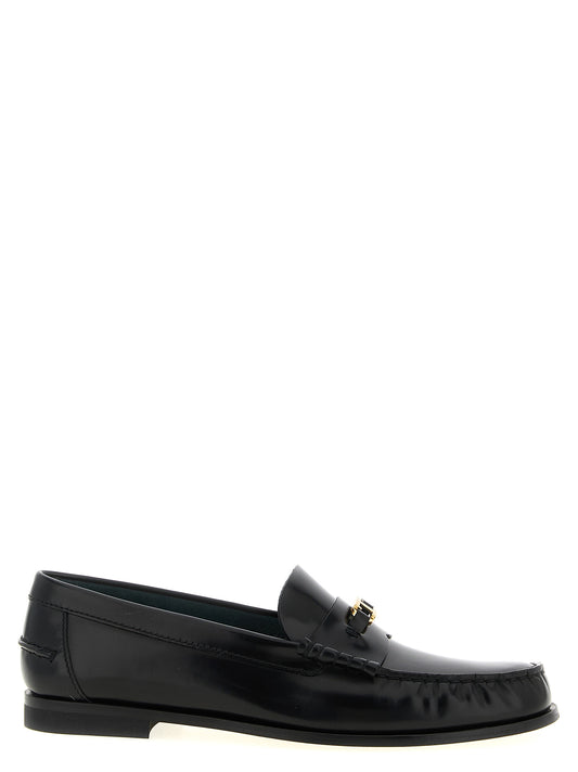 Flat Loafer Slip-On Shoes by Tod's for women in calfskin leather black & gold features an effortless chic silhouette, showcasing the T Timeless Women's Calfskin Leather Flat Loafer Slip-On Shoes design with an effortless chic flat and a for a effortless chic look.