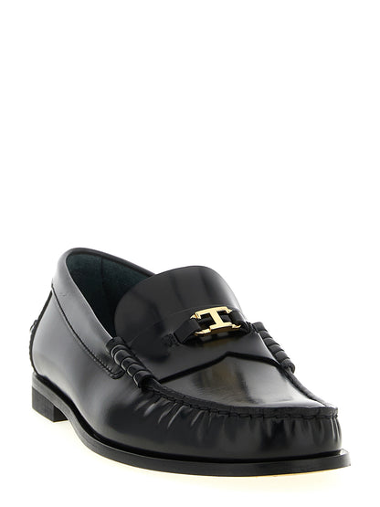Flat Loafer Slip-On Shoes by Tod's for women in calfskin leather black & gold showcases a resplendent T Timeless Women's Calfskin Leather Flat Loafer Slip-On Shoes aesthetic, defined by its resplendent and elegant flat.