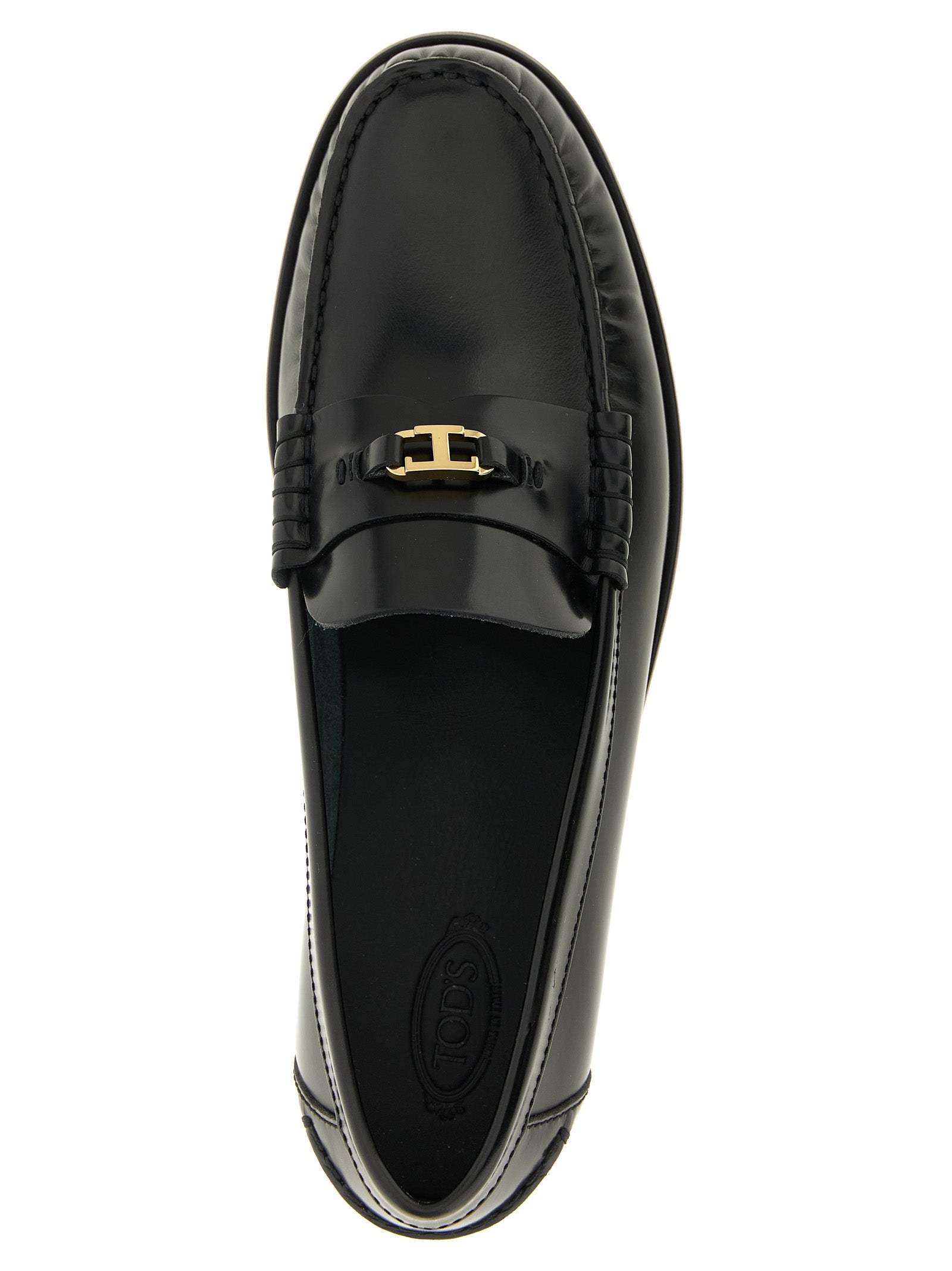 Flat Loafer Slip-On Shoes by Tod's for women in calfskin leather black & gold showcases a timeless silhouette from the T Timeless Women's Calfskin Leather Flat Loafer Slip-On Shoes collection, featuring a timeless flat and for a timeless finish.