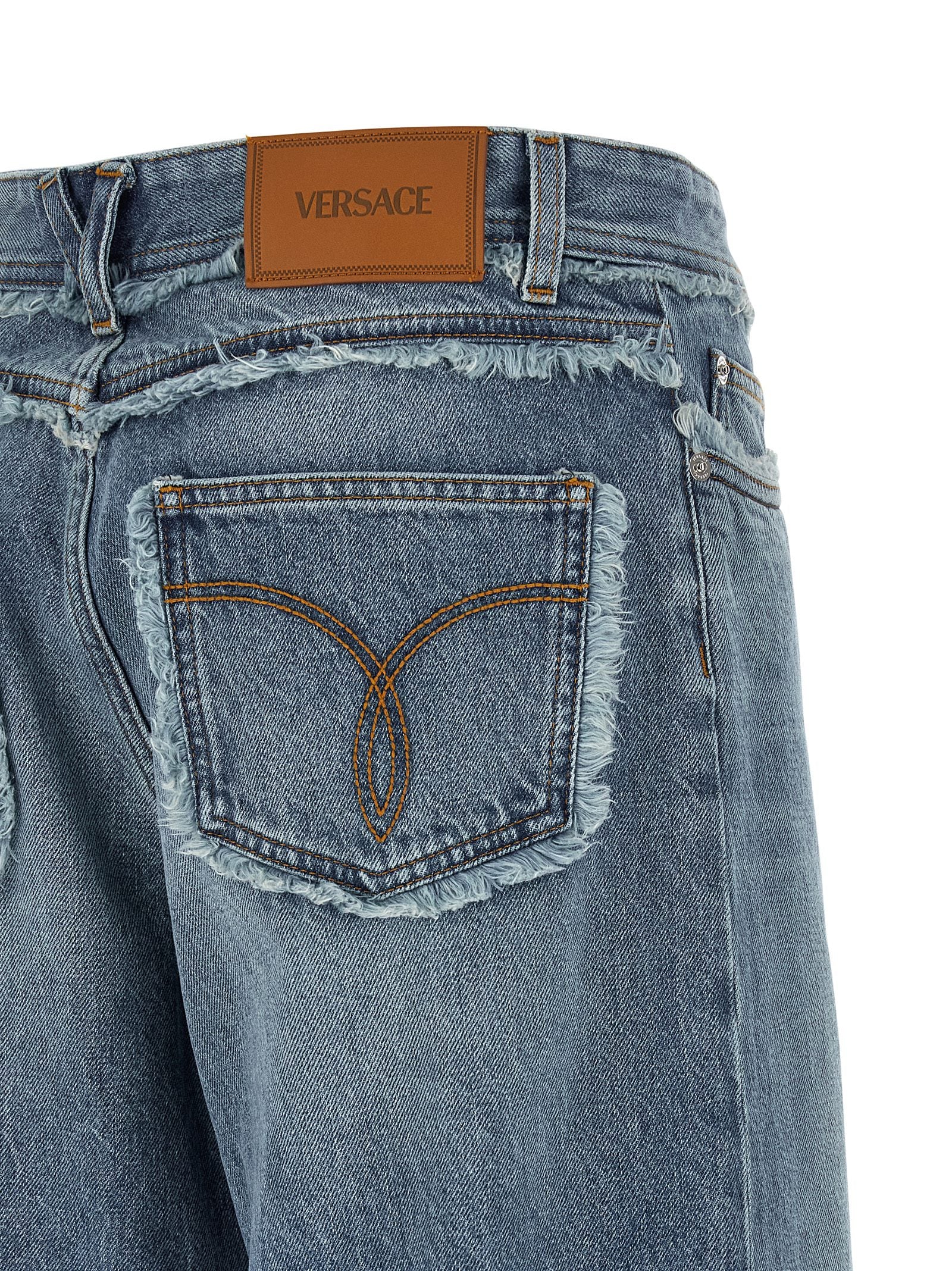 Jeans by Versace for women in cotton denim blue & signature features an sartorial relaxed-fit, wide & boyfriend and long with a low rise cut for a sartorial finish.