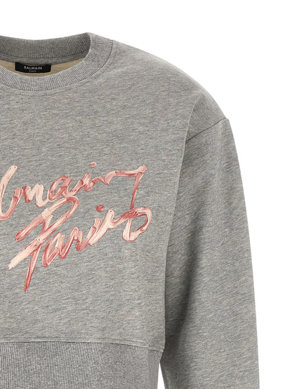 Activewear Sweatshirt by Balmain for women in cotton gray & print presents a dynamic silhouette, featuring a dynamic crew neckline and detailed with functional .
