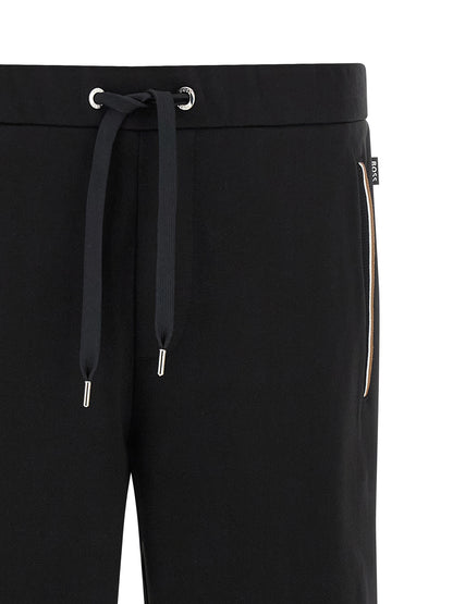 Joggers by Hugo Boss for men in cotton black & striped features an sartorial and long with a cut for a sartorial finish.